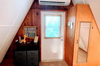 a room with a staircase with a door and a window at Cottage-pvt Lake & Pool Access Near Disney Wporch in Clermont