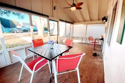 a dining room with red chairs and a table at Cottage-pvt Lake & Pool Access Near Disney Wporch in Clermont