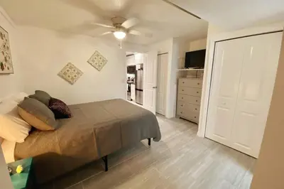 a bedroom with a bed and a white door at Lilac Loft- Lake, Pool, Pickle Ball, Disney, Fun! in Clermont