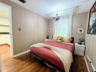 a bedroom with a bed with a red blanket at Stay The Enchanted Escape ! in Clermont