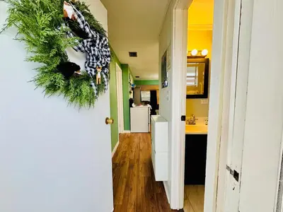 a hallway with a christmas wreath on the wall at Stay The Enchanted Escape ! in Clermont
