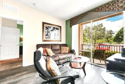 a living room with a couch and a table at LOCATION - Clubhouse & Pool in Orlando