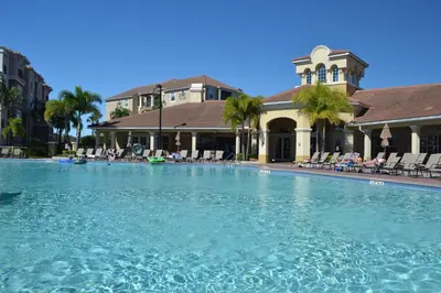 a large swimming pool in front of a building at LOCATION - Clubhouse & Pool in Orlando