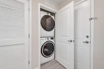 a laundry room with a washer and dryer at WOW New Upscale Penthouse in Orlando