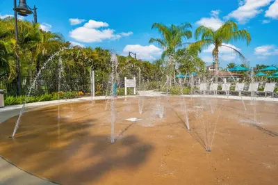 a water fountain in a park with palm trees at WOW New Upscale Penthouse in Orlando