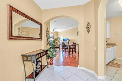 a kitchen and dining room with a mirror on the wall at Penthouse Corner at Vista Cay in Orlando