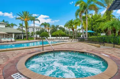 a hot tub with palm trees in the background at Penthouse Corner at Vista Cay in Orlando