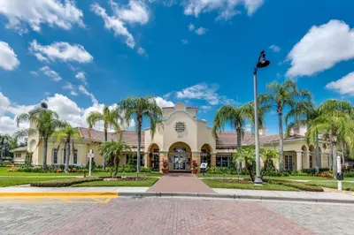 a building with palm trees in front of it at Penthouse Corner at Vista Cay in Orlando