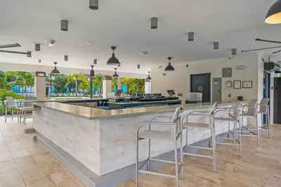 a bar with white chairs and a counter at Conservation View Updated WOW in Orlando