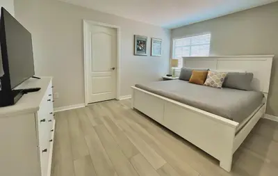 a bedroom with a bed and a flat screen tv at Cheerful 5 Bdr Sunny Pool in Kissimmee