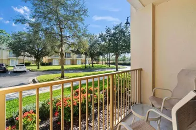 a balcony with chairs and a view of a street at Vista Cay Remodeled WOW in Orlando