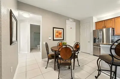 a kitchen and dining room with a table and chairs at Direct Lake Front View Luxury in Orlando