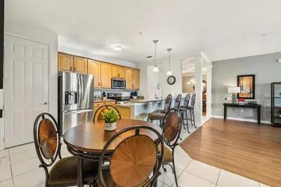 a kitchen and dining room with a table and chairs at Direct Lake Front View Luxury in Orlando