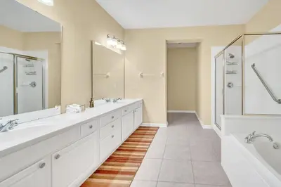 a bathroom with two sinks and a large mirror at WOW Huge Stunner Corner in Orlando