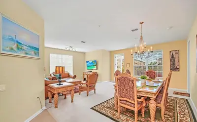 a dining room and living room with a table and chairs at WOW Huge Stunner Corner in Orlando