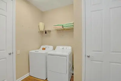 a small laundry room with a washer and dryer at Huge Updated Stunner Corner in Orlando