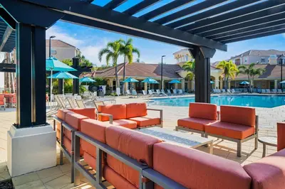 a patio with chairs and a swimming pool at Huge Updated Stunner Corner in Orlando