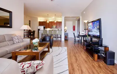 a living room with a couch and a table at WOW Upscale Penthouse in Orlando