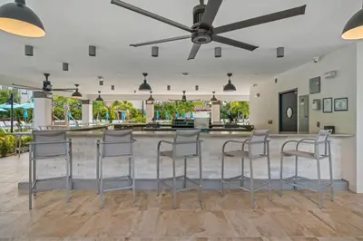 a bar with stools in the middle of a room at Lake & Pool View Fireworks in Orlando