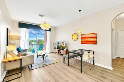 a living room with a table and a dining room at Lake & Pool View Fireworks in Orlando