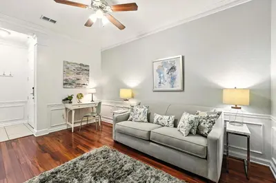 a living room with a couch and a ceiling fan at Huge Luxury Ground Floor 103 in Orlando