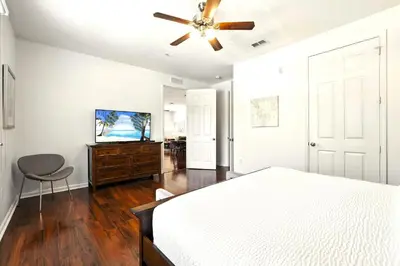 a bedroom with a bed and a ceiling fan at Huge Luxury Ground Floor 103 in Orlando
