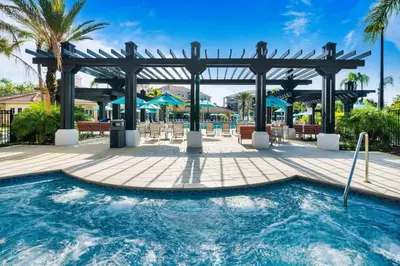 a pool at a resort with a pergola at Huge Luxury Ground Floor 103 in Orlando