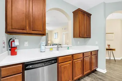 a kitchen with wooden cabinets and a dishwasher at Totally Remodeled Beauty WOW in Orlando