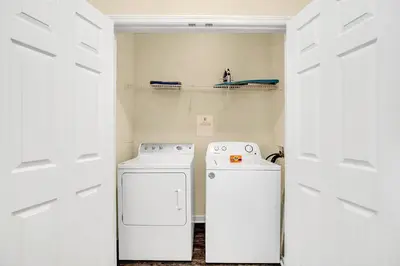 a laundry room with a washer and dryer at Totally Remodeled Beauty WOW in Orlando