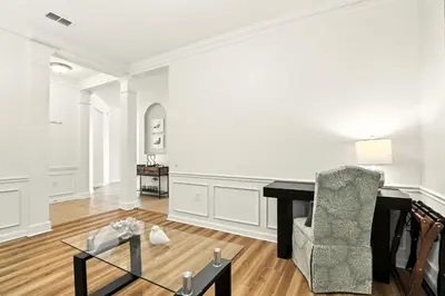 an empty living room with a desk and a chair at Huge Stunning Corner Home 304 in Orlando
