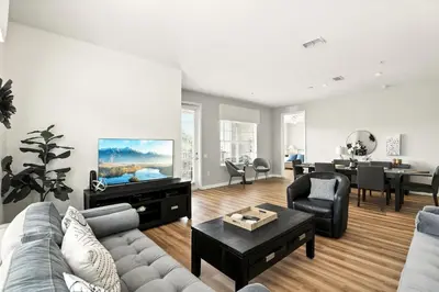 a living room with a couch and a tv at Huge Stunning Corner Home 304 in Orlando