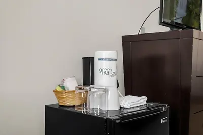 a black cabinet with a counter top with a coffee maker at Stylish King Apt w Arcade Game & BBQ Near Disney in Orlando