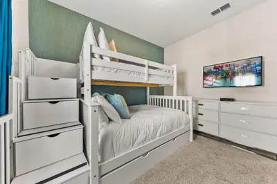 a bedroom with a white bunk bed and a dresser at Gorgeous 5Bd w Pool & Lazy River at Storey Lake 4989 in Kissimmee