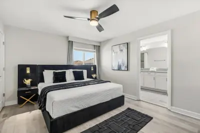 a bedroom with a bed and a ceiling fan at 5 Bedrooms 4 Bathrooms Storey Lake 4984Wa in Kissimmee