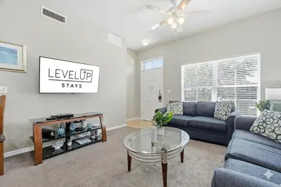 a living room with a couch and a table at Disney 8mi Heated Resort Pool Hot Tub Fitness in Kissimmee
