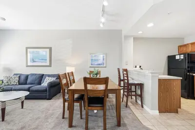 a living room with a couch and a table at Disney 8mi Heated Resort Pool Hot Tub Fitness in Kissimmee