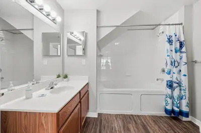 a white bathroom with a sink and a shower at Disney 8mi Heated Resort Pool Hot Tub Fitness in Kissimmee