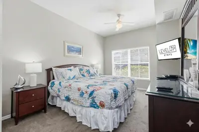 a bedroom with a bed and a dresser and a window at Disney 8mi Heated Resort Pool Hot Tub Fitness in Kissimmee