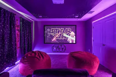 a star wars room with red chairs and a tv at 9 MI to Disney w Pool Cinema & FREE Waterpark in Kissimmee