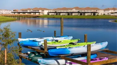 a group of boats tied to a dock in the water at 9 MI to Disney w Pool Cinema & FREE Waterpark in Kissimmee