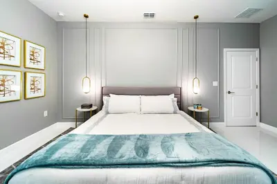 a bedroom with a large bed with two side tables at Themed 9BR Retreat Pool & Soccer Fun in Kissimmee