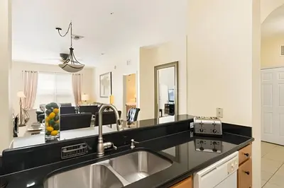 a kitchen with a sink and a counter top at Condo 3Q Windsor Hills — Perto da Disney in Orlando