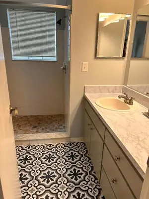 a bathroom with a sink and a mirror at Disney Magic Condo 1st Flr 3BR Disney-Themed Pool in Kissimmee