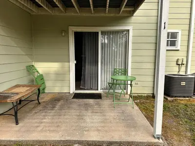 two chairs and a table on the porch of a house at Disney Magic Condo 1st Flr 3BR Disney-Themed Pool in Kissimmee