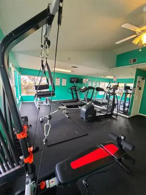 a gym with several exercise equipment in a room at 3beds 2baths Condo in Kissimmee, FL in Kissimmee
