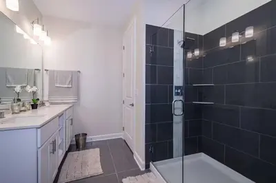 a bathroom with a shower and a sink at Spacious Villa w Pool Slides and Lush Nature Views in Kissimmee
