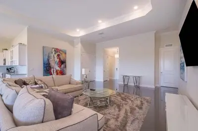 a living room with a couch and a table at Spacious Villa w Pool Slides and Lush Nature Views in Kissimmee