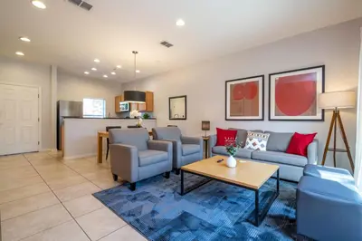 a living room with a couch and chairs and a table at Beautiful 2 bedrooms with Hot tube in Kissimmee