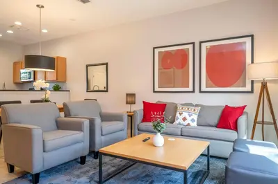 a living room with couches and a table at Beautiful 2 bedrooms with Hot tube in Kissimmee