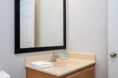 a bathroom with a sink and a mirror at Beautiful 2 bedrooms with Hot tube in Kissimmee
